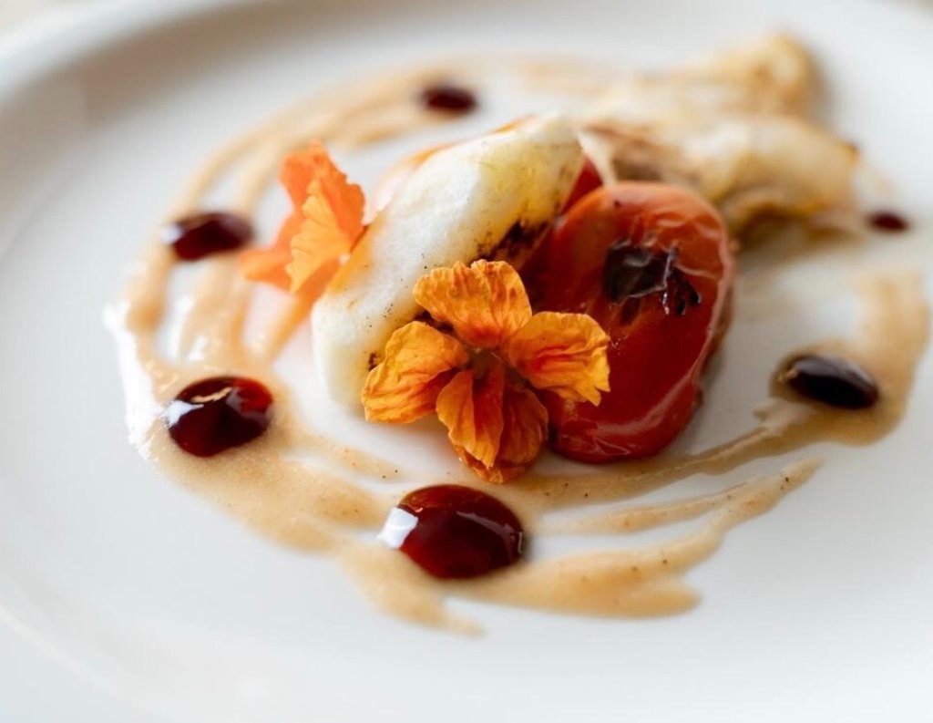 Seared white fish with edible flowers — a private chef plated course